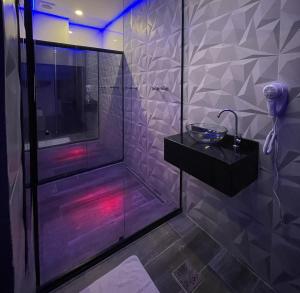 a bathroom with a shower with a glass shower stall at Lina Motel Tatuapé in Sao Paulo