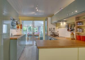 a large kitchen with a counter and a table at 11a Waterhead Close in Kingswear