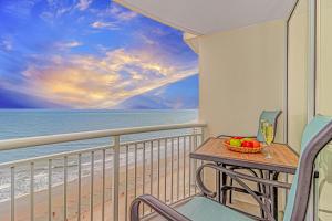 a table with a bowl of fruit on a balcony with the beach at Direct Oceanfront Condo-Sandy Beach Resort 1610- Sleeps 6! in Myrtle Beach