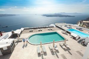 a view of a swimming pool and the ocean at Caldera Butterfly Villas in Fira
