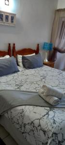 two beds in a bedroom with at Holiday unit 54 Eden Dunes in Shelly Beach