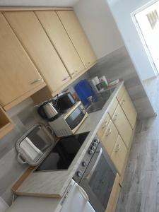 a small kitchen with a sink and a stove at Apartments Marija in Vir +5 photos
