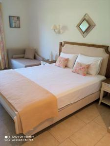 a bedroom with a large bed with two pillows at Bellarias House in Nydri