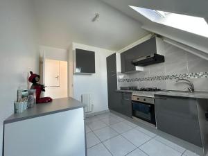 a kitchen with a sink and a stove at MAGNIFICENT Family Flat Self checkin avb in Garges-lès-Gonesse