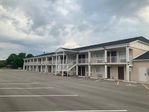 an empty parking lot in front of a hotel at Town & Country Inn in Troy