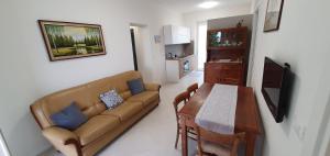 a living room with a couch and a table at casa nel verde della Val di Vara in Serò +6 photos