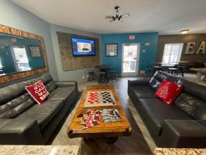 a living room with a couch and a table with chess at River Hills Hotel- Mankato in Mankato