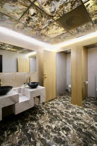 a bathroom with two sinks and a painting on the ceiling at Super Stay Hotel, Oslo in Oslo