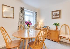 a dining room with a wooden table and chairs at Abbey Mews in Torquay