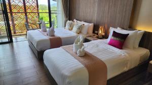 Postel nebo postele na pokoji v ubytování Alaita Boutique Phuket