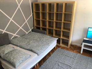 a room with a bed and a book shelf at Silver Apartments - Orientarium,Aquapark Fala & Park in Łódź +19 photos