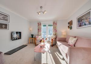 a living room with a couch and a table at 4 Hesketh Mews in Torquay