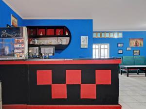 a red and black bar in a restaurant at OYO 92605 Hotel Las Vegas in Kopeng