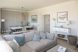 a living room with a couch and a dining room at Strandene (63 Strand Road) in Portstewart