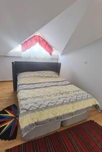 a small bed in a room with a window at Sunshine Guest house with terrace in Fethiye