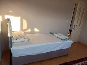 a small bed in a room with a window at Sunshine Guest house with terrace in Fethiye