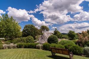 a park bench sitting in the middle of a field at San Giovanni Terme Rapolano in Rapolano Terme