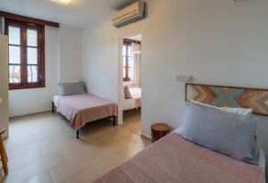 a bedroom with a bed and a chair in a room at Bouti Ayvalık in Ayvalık