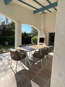 a table and chairs sitting on a patio at Villa Les Folies - magnifique jardin avec piscine in Le Beausset +23 photos