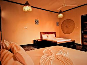 a bedroom with a bed and a bed and a bed at La Fontana Zanzibar in Kendwa +192 photos