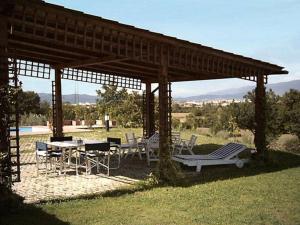 a gazebo with a table and chairs under it at Villa Paola in Arezzo