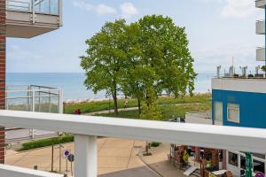 a view of the ocean from the balcony of a building at Strandvilla 27, Turmwohnung in Scharbeutz