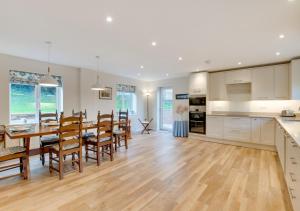 a kitchen and dining room with a table and chairs at Valley View in Colyton