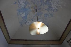 a light fixture hanging from a ceiling in a room at Palazzo sul Corso-Charming Appartaments in Brindisi