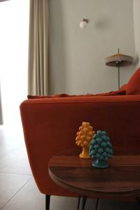 a table with two succulents on top of a couch at Palazzo sul Corso-Charming Appartaments in Brindisi +67 photos