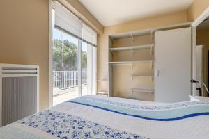 a bedroom with a bed and a large window at L'Hollywood Zen in Saint-Jean-de-Monts