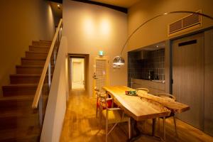 a dining room with a wooden table and a staircase at Bitotsuyama-an Bettei 美都津山庵別邸 #LB1 in Tuyama