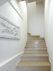 a staircase in a house with a picture on the wall at La Residenza di Opera Arte in Numana