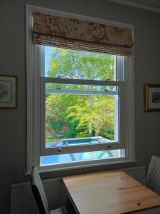 a window with a wooden table in front of it at Number 8 Cheltenham in Cheltenham