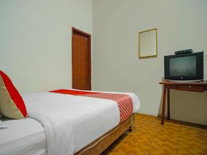 Voodi või voodid majutusasutuse OYO 92577 Hotel Sidikalang toas