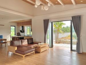 a living room with a couch and a table at LENA Homestay Phú Quốc in Phu Quoc