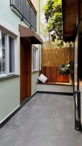 a porch of a house with a wooden door and a fence at Mimoza Hotel in Oludeniz