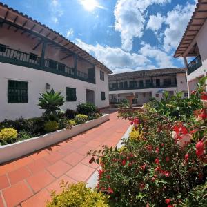 a courtyard of a building with flowers and plants at Hotel Abahunza in Villa de Leyva