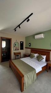 a bedroom with a large bed and a desk at Mimoza Hotel in Oludeniz