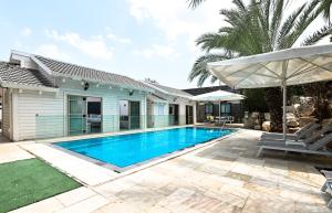 a swimming pool in the backyard of a house at YalaRent - Liri Resort in Tiberias