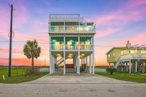a large house with a balcony on top of it at A Wave From It All - The Ocean Aire, 30 secs from the sand! in Galveston