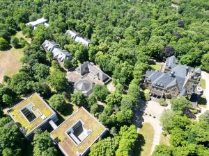 an aerial view of a large house in the woods at Ferienhaus Budenheim in Budenheim
