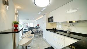 a white kitchen with a sink and a toilet at Apartamenty Every Sky Poznańska 21 in Jelenia Góra