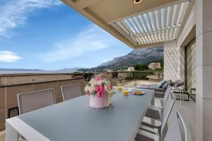 a balcony with a table with flowers on it at Apartment Ocean View in Tučepi