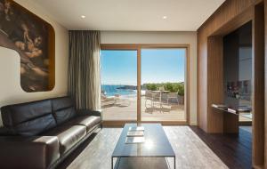 a living room with a couch and a view of the ocean at Pure Salt Port Adriano - Adults Only in Santa Ponsa +112 photos