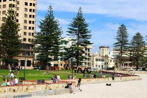 a group of people on the beach in a park at Lovely "Driftwood Taft" Apartment Beach & Everything few Minutes walk! Central Glenelg in Glenelg
