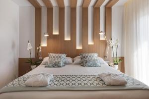 a bedroom with a large white bed with pillows at Pure Salt Garonda - Adults Only in Playa de Palma