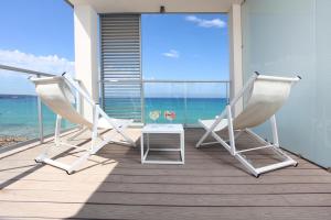 two chairs and a table on a balcony with the ocean at Pure Salt Garonda - Adults Only in Playa de Palma