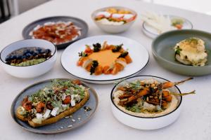 a group of plates of food on a table at THE FLAG Costa del Sol Marbella, Estepona in Estepona