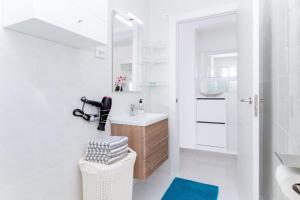 a white bathroom with a sink and a mirror at La Mata Londres 2 in La Mata +14 photos