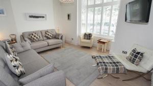 un soggiorno con divano e TV di Promenade View a The Mumbles